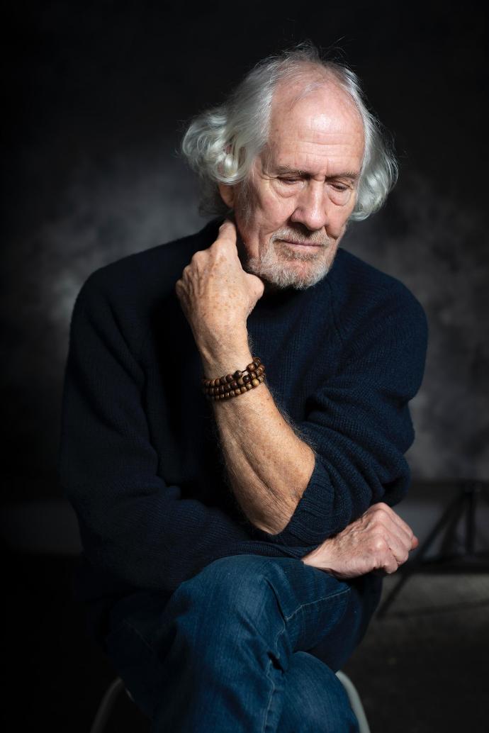 man in black long sleeve shirt sitting on chair